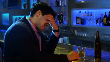 Depressed-man-having-beer-at-counter