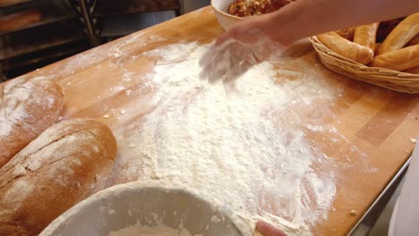 Baker-spreading-dough-on-counter