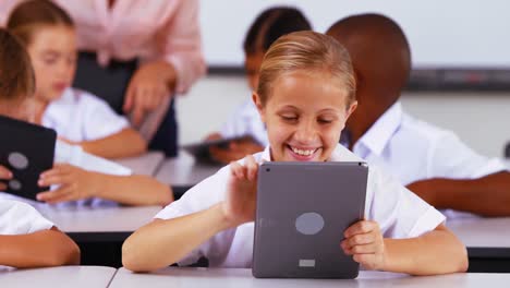Schoolgirl-using-digital-tablet-in-classroom