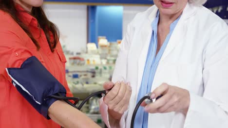 Pharmacist-checking-blood-pressure-of-customer