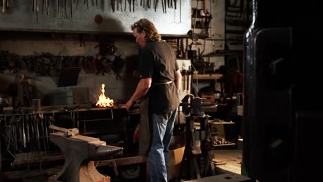 Blacksmith-working-at-workshop