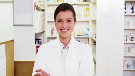Pharmacist-standing-with-arms-crossed-in-pharmacy