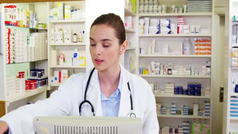 Pharmacist-making-prescription-record-on-computer