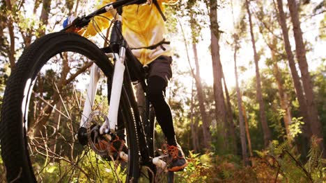 Female-mountain-biker-riding-in-the-forest