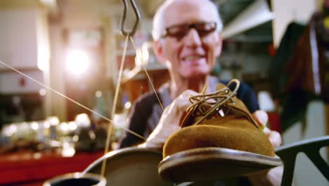 Shoemaker-examining-a-shoe