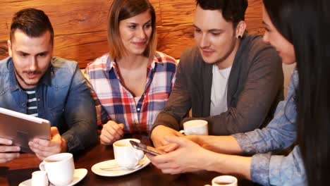Friends-interacting-while-having-a-cup-of-coffee