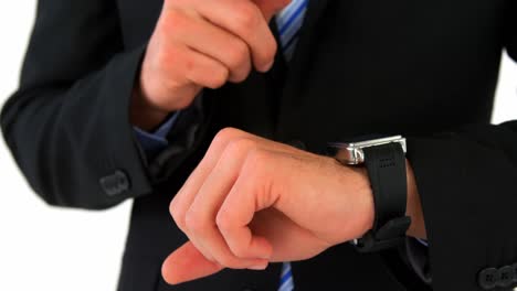 Mid-section-of-businessman-using-his-smart-watch