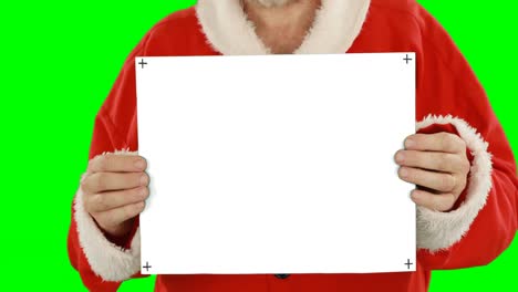Mid-section-of-santa-claus-holding-blank-placard