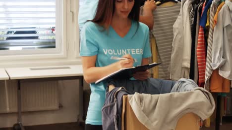 Freiwillige-Frau,-Die-Kleidung-überprüft
