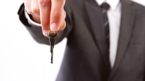 Mid-section-of-businessman-holding-keys