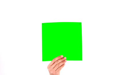 Man-holding-green-blank-paper