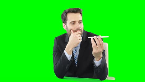 Businessman-with-mobile-phone-touching-digital-screen