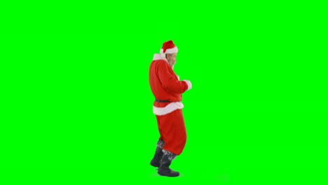 Santa-claus-dancing-against-green-background