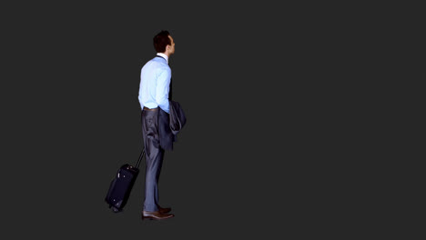 Businessman-standing-with-his-luggage