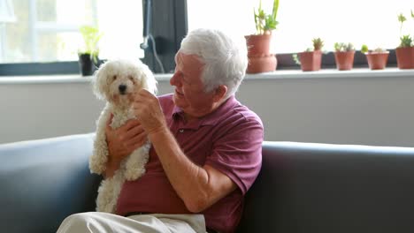 Senior-man-pampering-dog