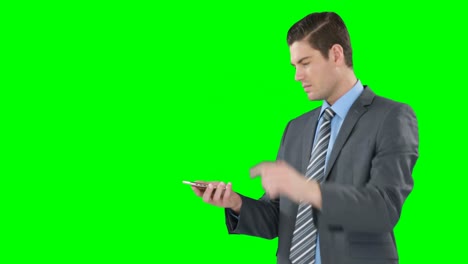 Young-businessman-gesturing-while-using-mobile-phone