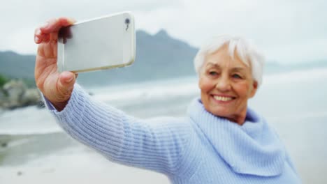 Ältere-Frau,-Die-Am-Strand-Ein-Selfie-Mit-Dem-Mobiltelefon-Macht
