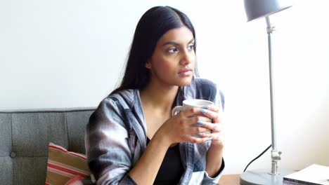 Thoughtful-woman-having-cup-of-coffee