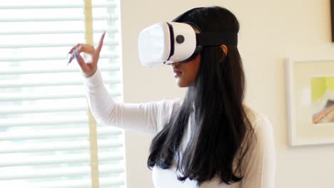 Woman-using-virtual-reality-headset-in-living-room