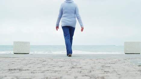 Senior-woman-walking-on-the-beach