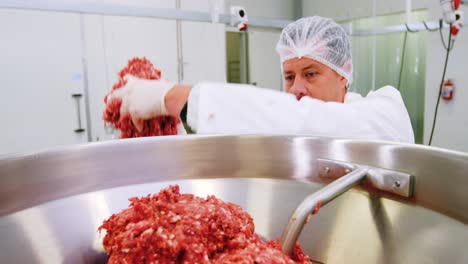 Butcher-preparing-minced-meat