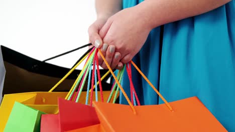 Woman-holding-shopping-bag-against-white-background