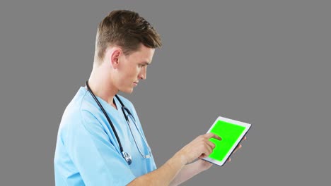 Male-surgeon-using-digital-tablet