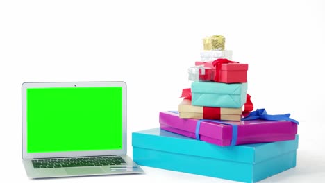 Stack-of-wrapped-gift-boxes-with-laptop