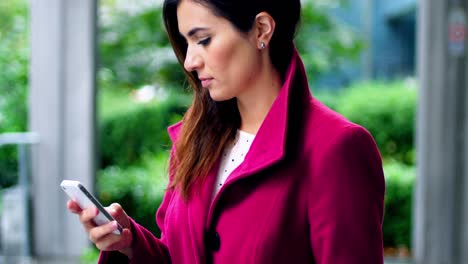 Businesswoman-using-mobile-phone-while-having-coffee