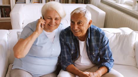 Senior-couple-talking-on-mobile-phone