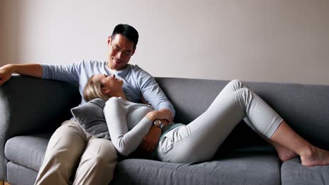 Couple-relaxing-on-sofa