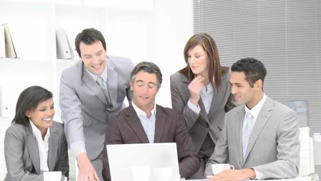 Business-team-applauding-a-colleague-in-office