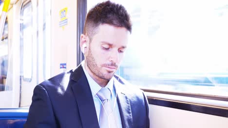 Businessman-listening-to-music-while-travelling