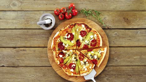 Delicious-pizza-with-ingredients-on-wooden-table