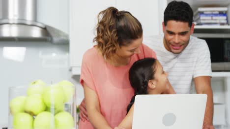 Happy-family-using-laptop-
