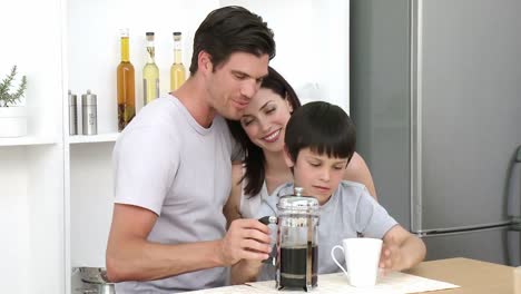Parents-and-son-preparing-coffee-in-the-kitchen