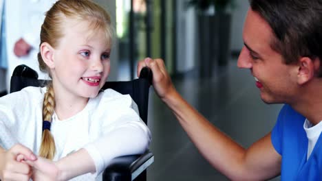 Doctor-interacting-with-disable-girl