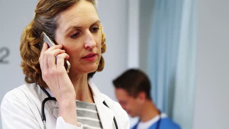 Female-doctor-talking-on-mobile-phone