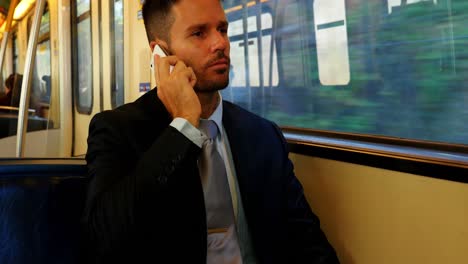 Businessman-talking-on-the-mobile-phone-while-travelling