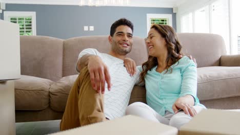Happy-couple-sitting-in-living-room