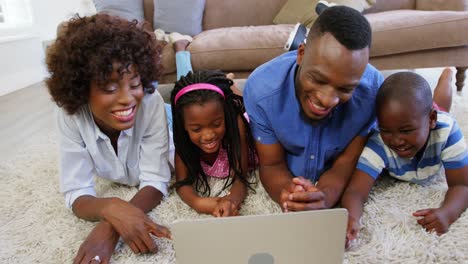 Family-using-laptop-in-living-room