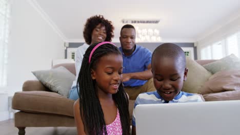 Children-using-laptop-in-living-room