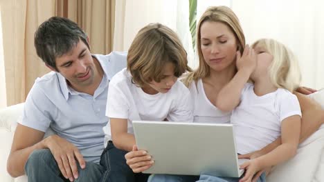 Family-at-home-using-a-laptop