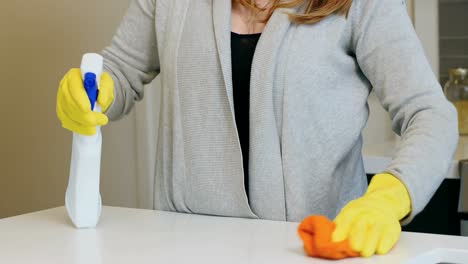Woman-cleaning-kitchen-worktop