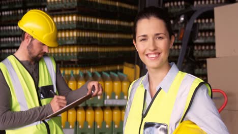 Portrait-of-female-supervisor-smiling-in-warehouse