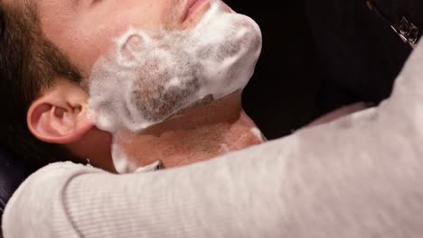 Man-getting-his-beard-shaved-with-razor