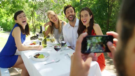 Man-taking-picture-of-his-friends-with-mobile-phone