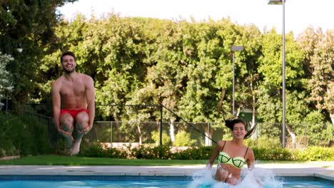 Couple-jumping-together-in-swimming-pool