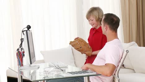 Man-using-a-computer-and-talking-to-his-son
