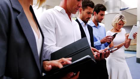 Business-executives-using-digital-tablet-and-mobile-phone